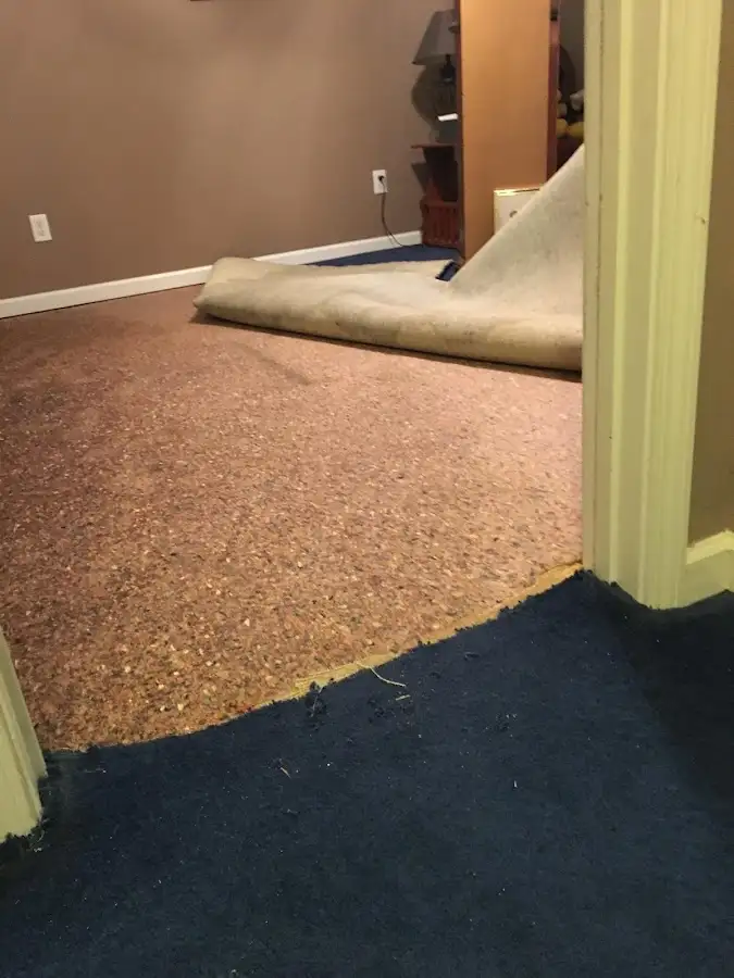 Carpet pad removal revealing water damage during Water Mitigation Services in Casas Adobes
